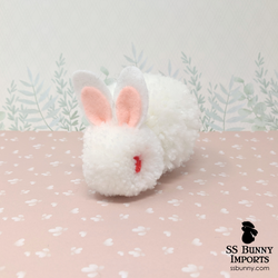 Ruby-eyed white pom pom bunny