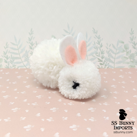 Black-eyed white pom pom bunny
