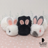 Black-eyed white pom pom bunny